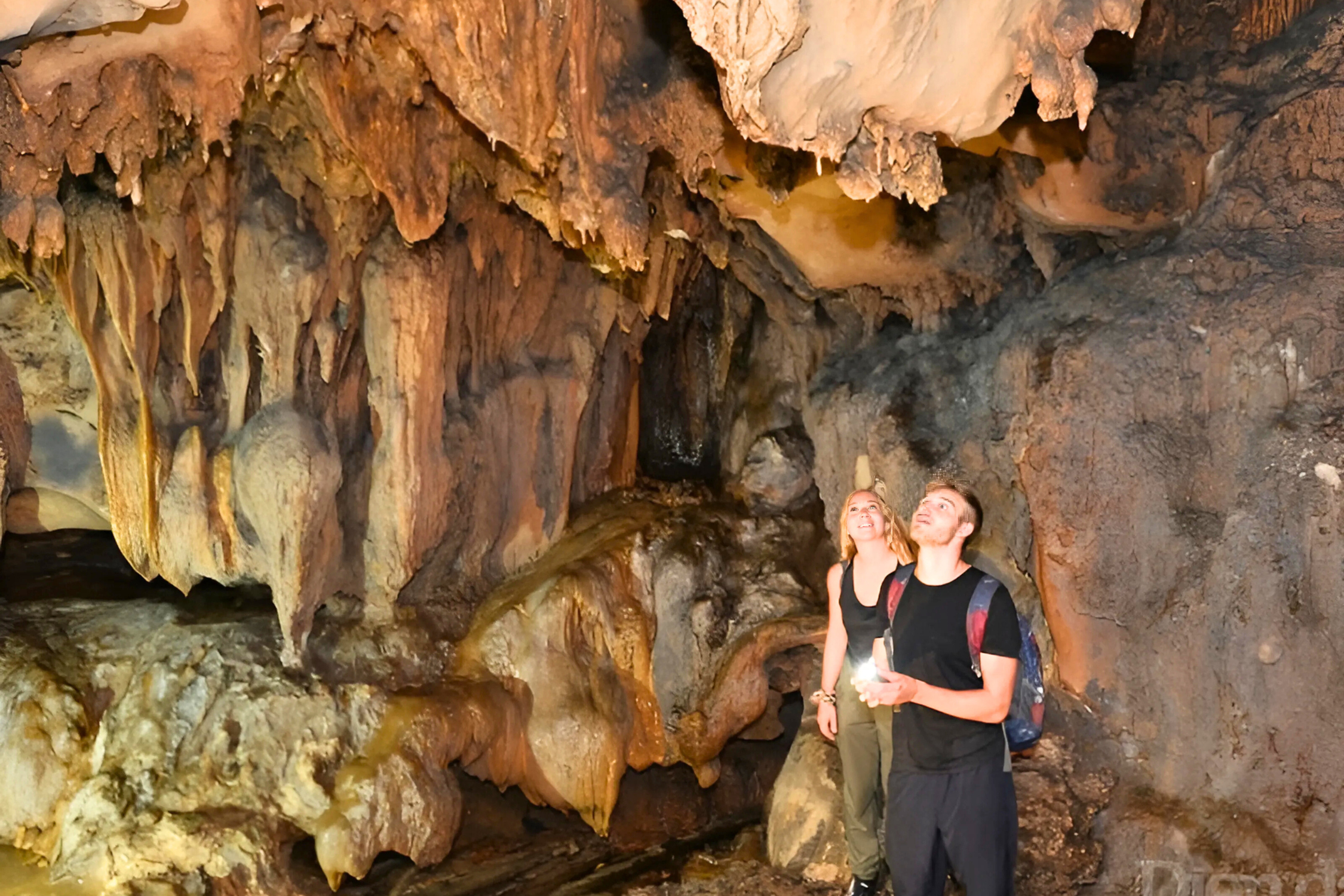 Visitors admiring impressive stalactites inside Trung Trang Cave