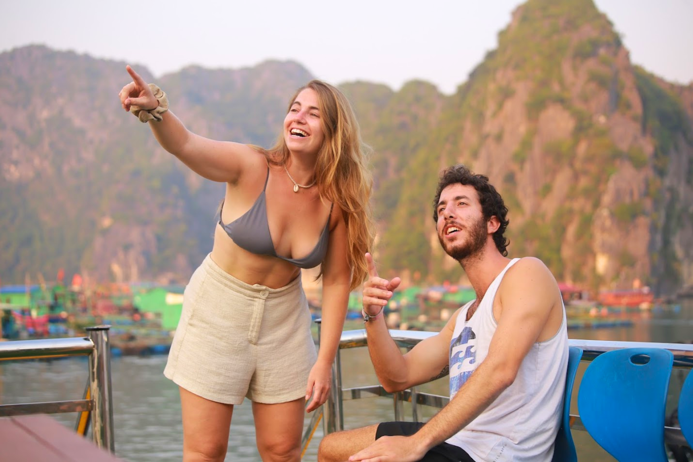 Tourist admiring the Lan Ha Bay sunset from the cruise deck