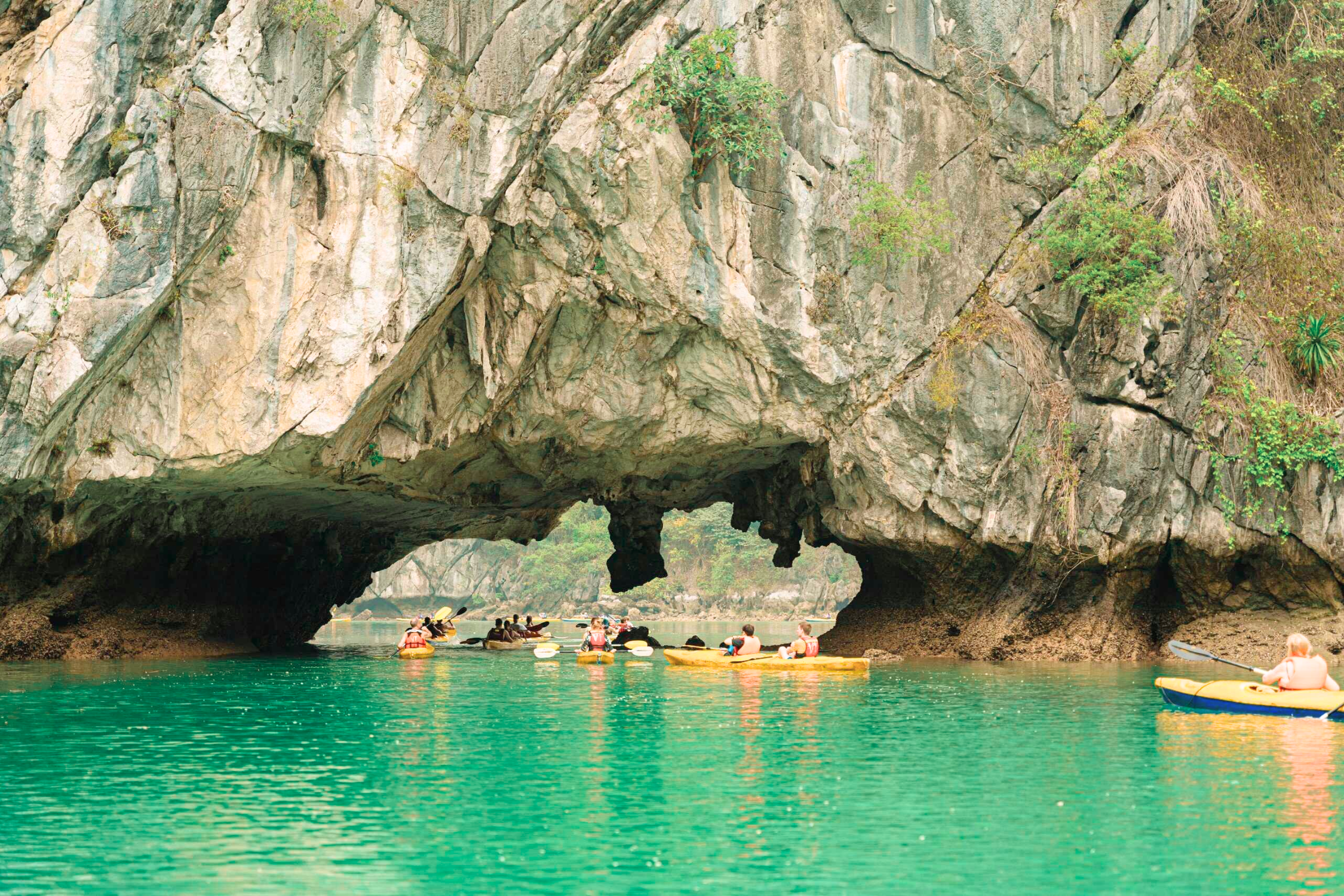 Tourist experiencing kayaking through the Dark & Bright Cave